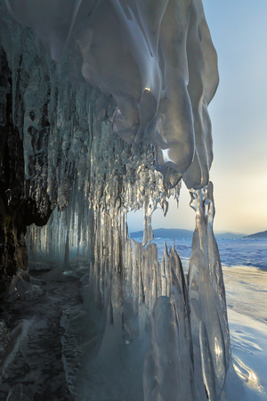 Ice stalactites and stalagmites in the rock. Beautiful winter landscape in the Lake Baikal.の写真素材