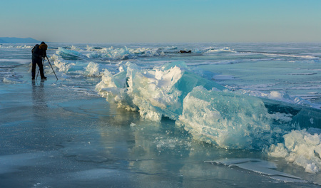 Photographers shoot blocks of ice. Beautiful winter landscape in the Lake Baikal.