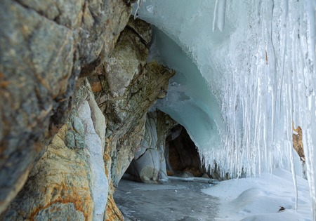 Multicolored stone grotto with icicles. Beautiful winter landscape in the Lake Baikal.の写真素材