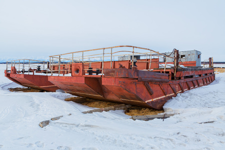 Ust-Barguzin, Russia - March 04, 2016: Ferry in frozen lake covered with snow in winter eveningのeditorial素材