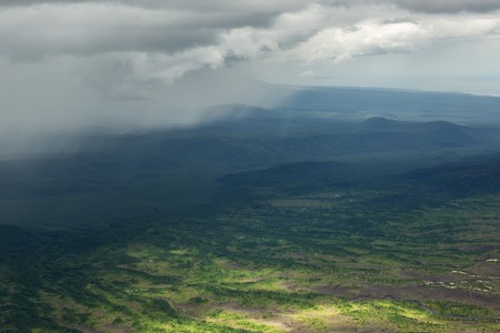 Rain in the Kronotsky Nature Reserve on Kamchatka Peninsula. View from helicopter.