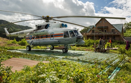 Kamchatka Peninsula, Russia - August 12, 2016: Helicopter landed on the ground near reserve administration in Valley of Geysers. Kronotsky Nature Reserve on Kamchatka Peninsula.のeditorial素材