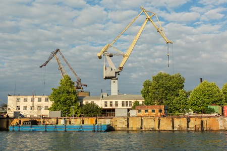 Sevastopol, Russia - June 09, 2016: Lifting cargo cranes at the shipyard in Bay of Black Sea.