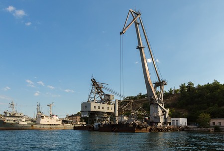 Sevastopol, Russia - June 09, 2016: Floating cranes lift trucks in the Bay of Black Sea.