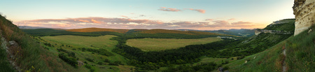 Evening panorama of the green valley. View from the top of the cave city Bakla in Crimea.の写真素材
