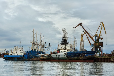 Petropavlovsk-Kamchatsky, Russia - August 15, 2016: Border patrol ships of the Coast Guard and harbor cranes near the coast of Kamchatka.のeditorial素材