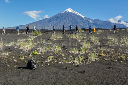 Kamchatka Peninsula, Russia - August 22, 2016: Group of tourists photographing Tolbachik Volcano, Klyuchevskaya Group of Volcanoes in Kamchatka.のeditorial素材