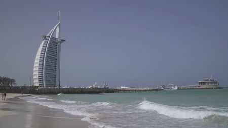 Dubai, UAE - April 01, 2018: Burj Al Arab Hotel on Public Jumeirah Open Beach on the coast of the Persian Gulf, Dubaiのeditorial素材