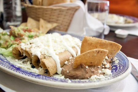 Enchiladas with cheese, beans, and vegetablesの写真素材