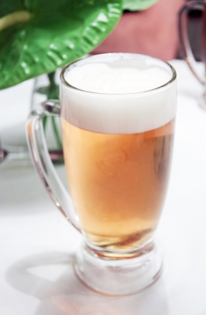 Glass of beer on the table at the restaurantの写真素材