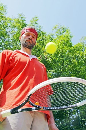 Young guy is palying a tennis matchの写真素材