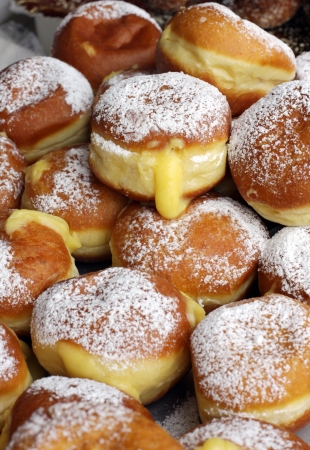 A lot of krapfen with sugar and creamの写真素材