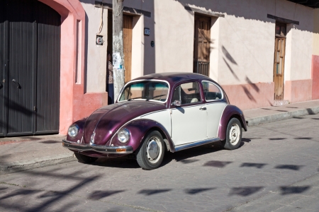 SAN CRISTOBAL DE LAS CASA, MEXICO - FEBRUARY 7, 2013  VW Beetle parked in a street in San Cristobal de las Casas, Mexico, on a sunny dayのeditorial素材