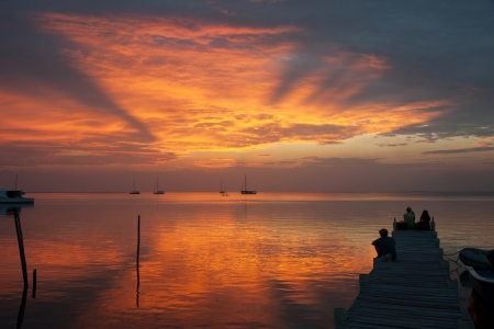 A couple looking at the sunset in Caye Caulker, Belize の写真素材