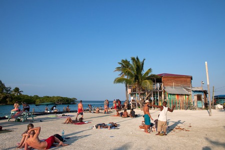 CAYE CAULKER, BELIZE - FEBRUARY 15, 2013  People leazing and drinking on the sunset in the  split of Caye Caulker, a small island located approximately 20 miles from Belize City, Belizeのeditorial素材