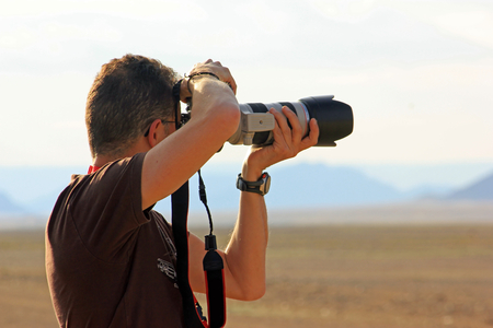 A photographer working outdoor wit reflex cameraの写真素材