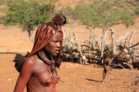 EPUPA, NAMIBIA- MAY 12, 2014: Portrait of an unidentified young Himba woman. The Himba are...