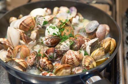 Cooking some clams with wine and parsley in the panの写真素材