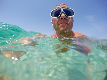 Swimming on the sea with googlesの写真素材