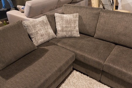 Modern grey sofa with two pillows