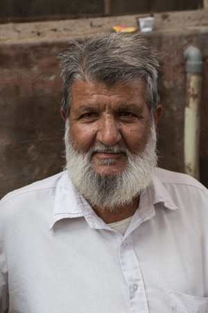 BIKANER, INDIA - OCTOBER 12, 2015: Portrait of an elderly Indian man with white beard in front of his home in Bikanerのeditorial素材