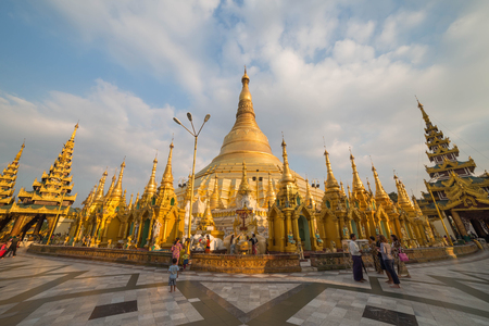 YANGON, MYANMAR - NOVEMBER 27, 2016: people walking and praying at the sunset  in the Shwedagon pagoda the most famous pagoda of southest Asia.のeditorial素材