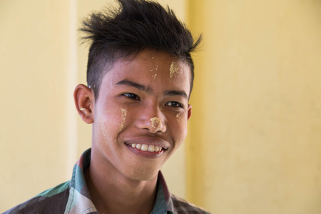 TWANTE, MYANMAR - NOVEMBER 27, 2016: burma smiling portrait of a boy with typical make up in Myanmarのeditorial素材