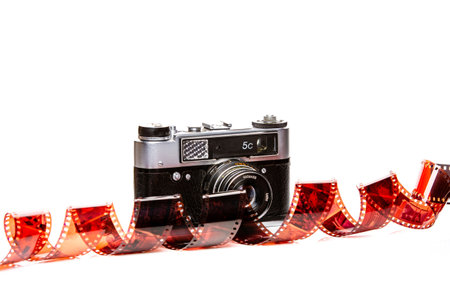 Photographer capturing images outdoors, professional camera equipment, telephoto lens, focus on subject, natural light, candid shot, photography hobby, rail tracks background, clear blue sky photoの写真素材