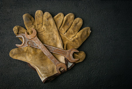 work gloves with wrenches, on background, metal, rust, retro tool, vintageの写真素材