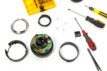 Camera lens repair view on white background with selective focus.の写真素材