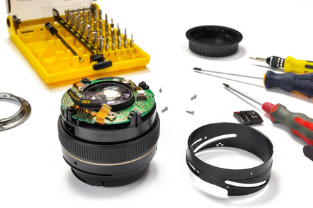 Camera lens repair view on white background with selective focus.の写真素材