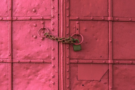 fresh painted old riveted iron double door with two ringsの写真素材