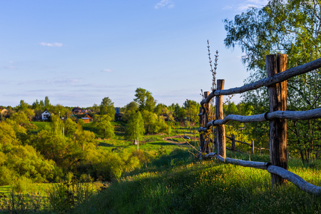 rustic view with log fence on hillの写真素材