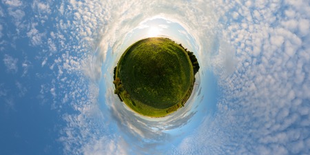 Sunset on meadow little planet panorama with 2 by 1 aspect ratio.の写真素材