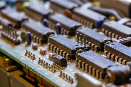 dark background of old electronic circuit board closeup with dus