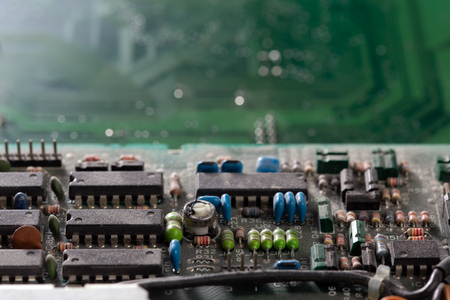 dark background of old electronic circuit board closeup with dus