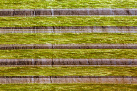 green striped synthetic woven upholstery fabric close-up texture and background