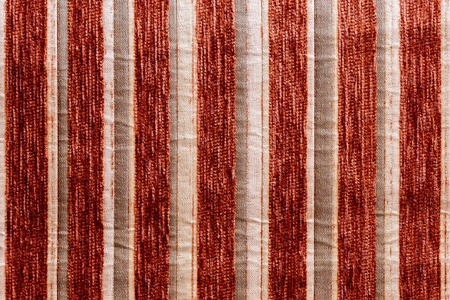 red vertical striped synthetic woven upholstery fabric close-up texture and background