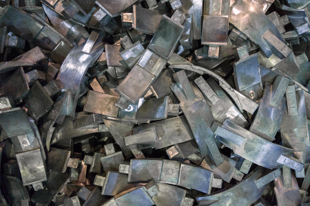 Many complex aluminium castings with burrs flat background with selective focus. View from aboveの写真素材