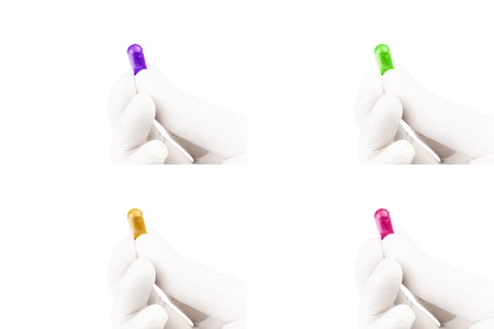 set of hand in medical glove holding colored organic med capsule isolated on white background...