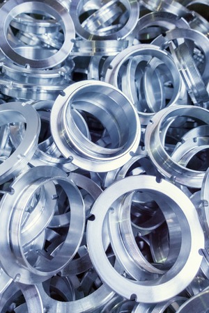 a batch of machined shiny metal parts with selective focusの写真素材