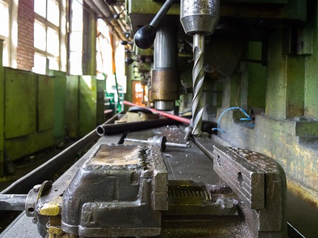 old drilling machine with obsolete used vice with selective focus