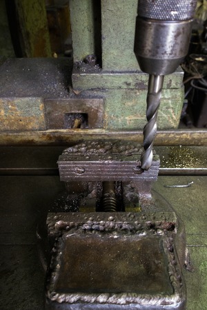old drilling machine with obsolete used vice with selective focus