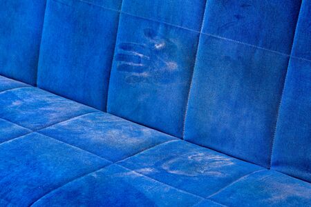 dusty blue sofa surface with palm prints closeup with selective focusの写真素材