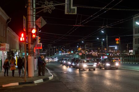 TULA, RUSSIA - APRIL 22, 2017: Dark night winter traffic and pedestrians on street crossroad with selective focusのeditorial素材