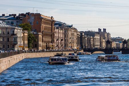SAINT-PETERSBURG, RUSSIA - MAY,09 2014: Fontanka river with tourist boats full of people. Telephoto...