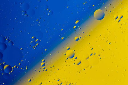 Oil on water flat colorful duotone macro abstract background photographic image.の写真素材