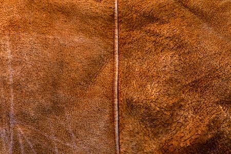small brown weathered seude jacket closeup texture with selective focus and blurの写真素材