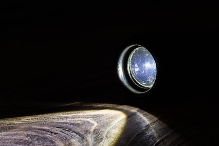 black led operational flashlight on rough wooden surface - closeup with selective focusの写真素材