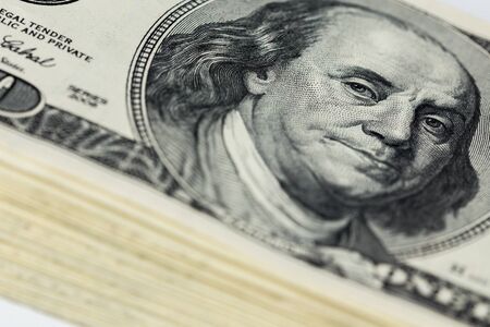 a skewed stack of old us dollar banknotes - close shot with selective focus and blur